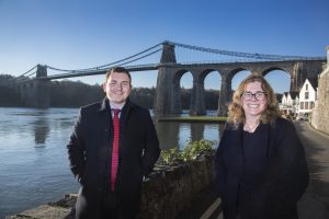 Pictured at Anglesey’s iconic Menai Bridge are Sara Lloyd Evans and Shaun Hughes of law firm Swayne Johnson who have just opened their first office on the island.
